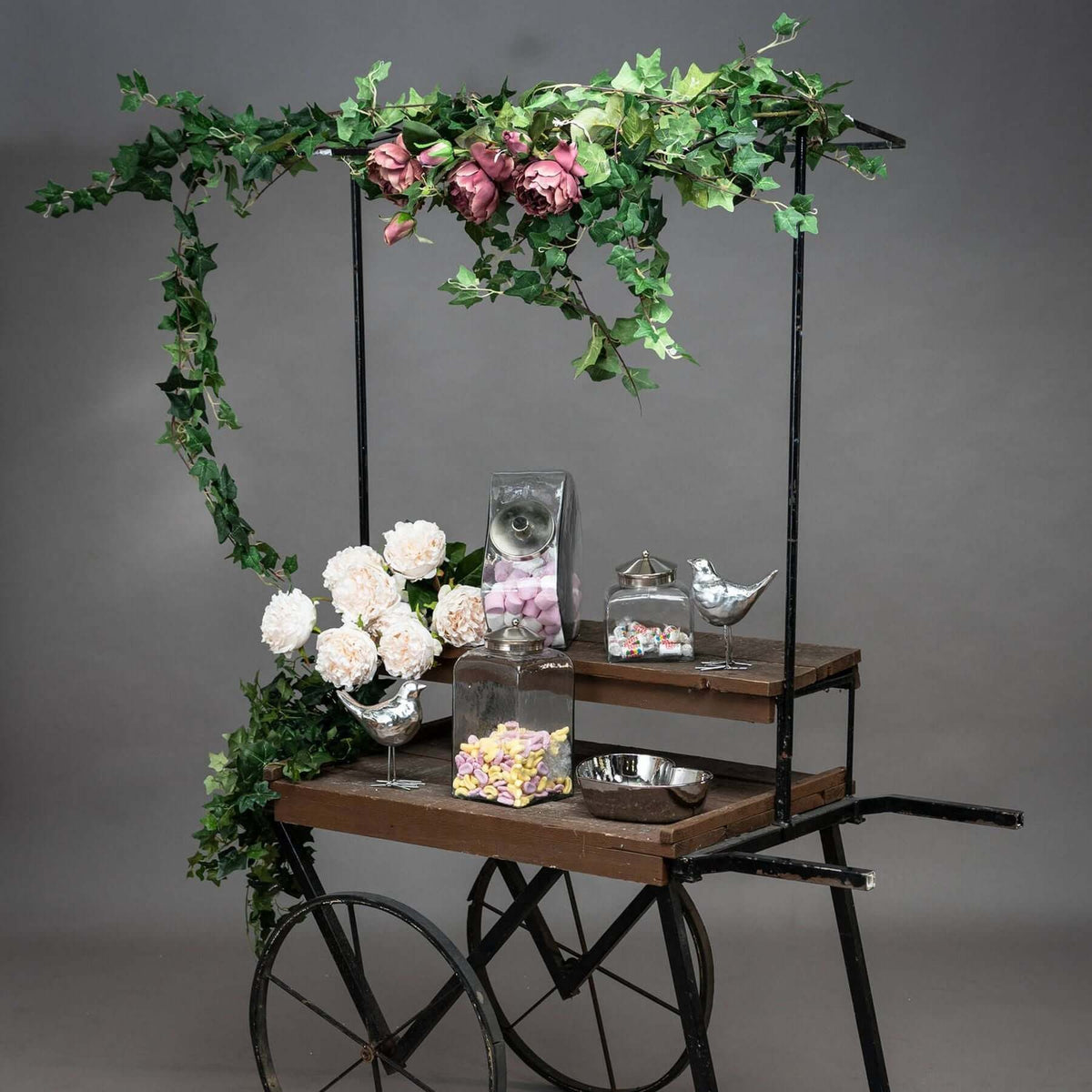 Ivy Garland drapes beautifully over a decorative cart filled with flowers and treats.