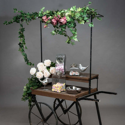 Ivy Garland drapes beautifully over a decorative cart filled with flowers and treats.