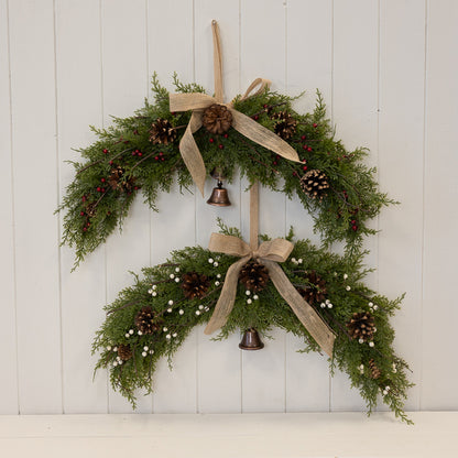 Arc Swag with White Berries, Pinecones with Bells and Bow Detail